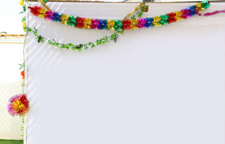 Jewish festival of Sukkot. Traditional succah (hut) from white fabric and colorful decorationsの写真素材