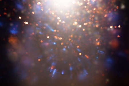 background of abstract gold, blue, purple and black glitter lights. defocused