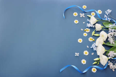 Top view image of white flowers composition over blue background .Flat layの写真素材