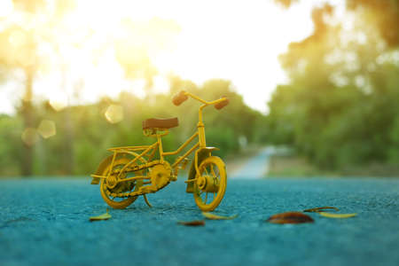 Blue vintage bicycle toy waiting outdoors at sunset lightの写真素材