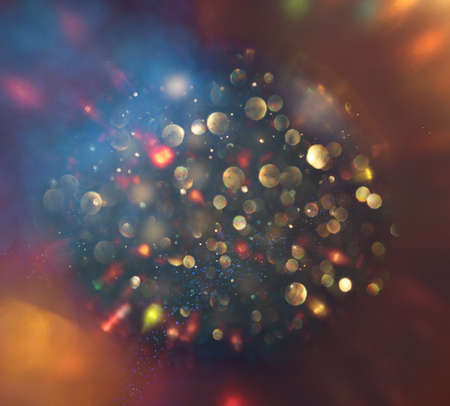 background of abstract gold and blue glitter lights. defocused
