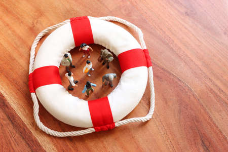 Concept image of life buoy protecting group of people. Rescue and support in times of crisis...