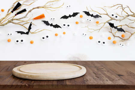 Halloween holiday concept. Empty rustic table in front of bare trees and bats background. Ready for product display montageの写真素材