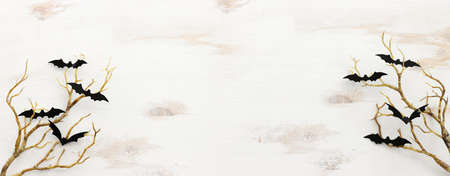 top view image of Halloween holoday. bare trees, bats over white wooden backgroundの写真素材