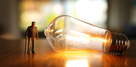 Concept image of elderly thinking, senior man looking at light bulbの写真素材