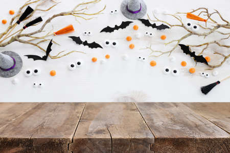 Halloween holiday concept. Empty rustic table in front of bare trees and bats background. Ready for product display montageの写真素材