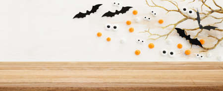 Halloween holiday concept. Empty rustic table in front of bare trees and bats background. Ready for product display montageの写真素材