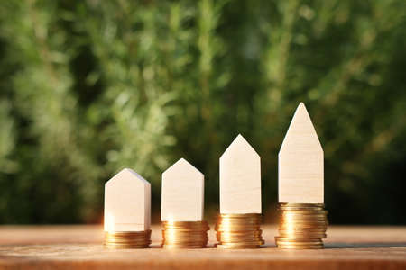 Wooden house model outdoors. Investment or real estate conceptの写真素材