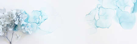 Creative image of pastel blue Hydrangea flowers on artistic ink background. Top view with copy spaceの写真素材