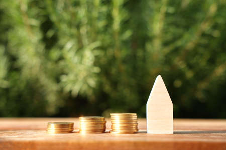 Wooden house model outdoors. Investment or real estate conceptの写真素材