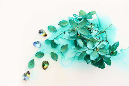 Creative image of emerald and green Hydrangea flowers on artistic ink background. Top view with copy spaceの写真素材