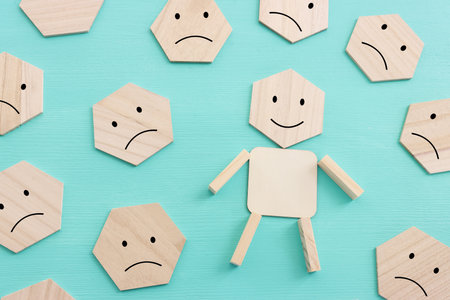 Concept image of satisfaction level. wooden cubes with emotionsの写真素材