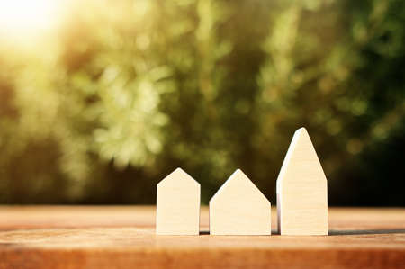 Wooden house model outdoors. Investment or real estate conceptの写真素材