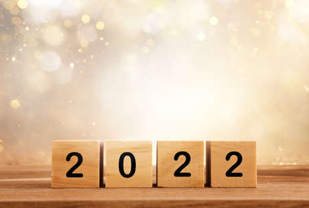 wooden cubes with the text 2022 over bright shiny backgroundの写真素材
