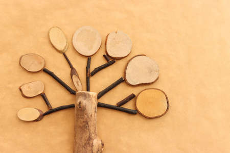Image of wooden growing tree on brown recycled paper background