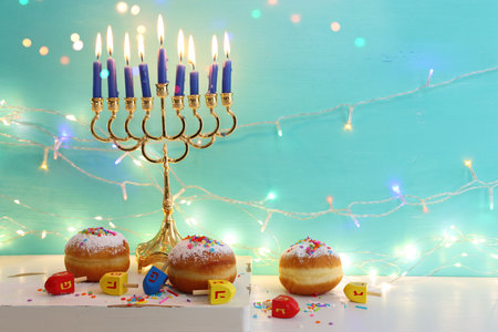 Religion image of jewish holiday Hanukkah background with menorah (traditional candelabra), doughnut and candlesの写真素材