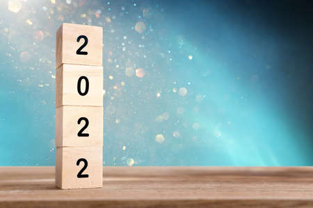 wooden cubes with the text 2022 over bright shiny background