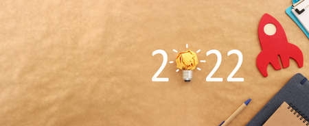 Background for 2022 - office supplies over brown recycled paper