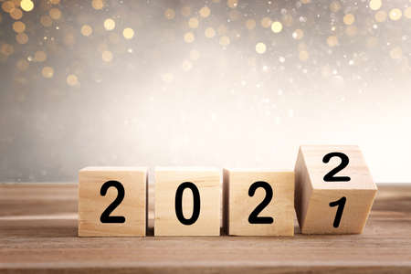 wooden cubes with the text 2022 over bright shiny backgroundの写真素材