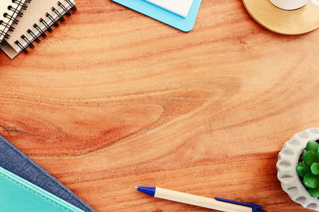 office desk table with notebook and other office supplies. Top view