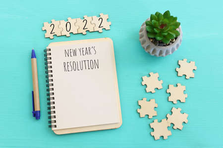 Business concept of top view 2020 goals list with notebook over wooden desk
