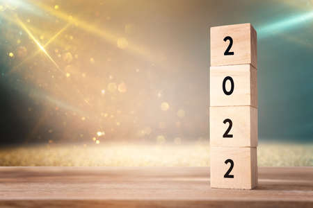wooden cubes with the text 2022 over bright shiny backgroundの写真素材