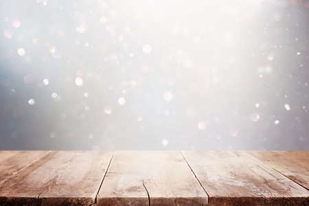 Empty table in front of silver glitter lights background. For product display montage