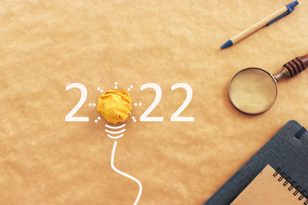 Background for 2022 - office supplies over brown recycled paperの写真素材