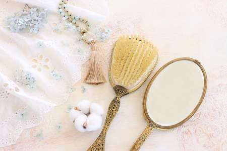 Background of white delicate lace fabric, neckless and vintage hand mirrorの写真素材