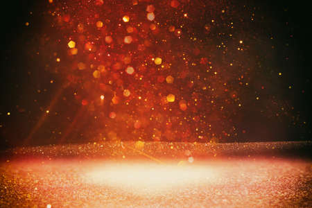 background of abstract red, gold and black glitter lights. defocused
