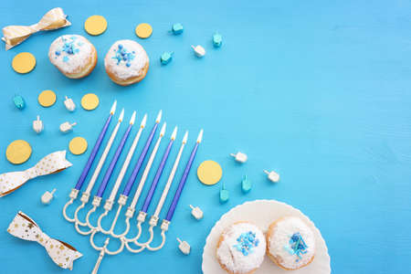 Religion image of jewish holiday Hanukkah background with menorah (traditional candelabra), doughnut and candlesの写真素材