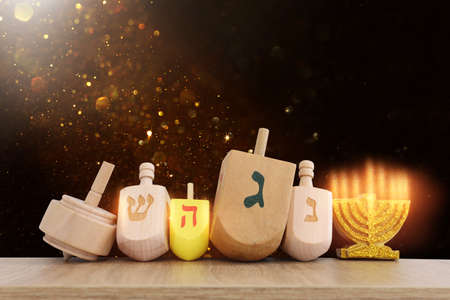 Image of jewish holiday Hanukkah with wooden dreidels collection (spinning top) over glitter backgroundの写真素材