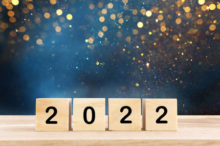 wooden cubes with the text 2022 over bright shiny backgroundの写真素材