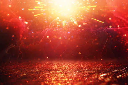 background of abstract red, gold and black glitter lights. defocused