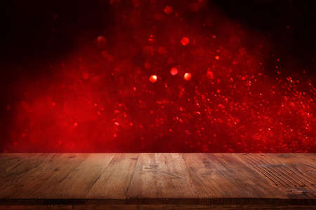 Empty rustic table in front of Valentine's day or christmas glitter bokeh background with gold...