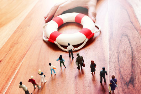Concept image of life buoy protecting group of people. Rescue and support in times of crisis metaphorの写真素材