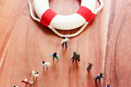 Concept image of life buoy protecting group of people. Rescue and support in times of crisis metaphorの写真素材