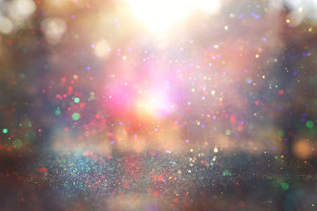 blurred abstract photo of light burst among trees and glitter golden bokeh lightsの写真素材