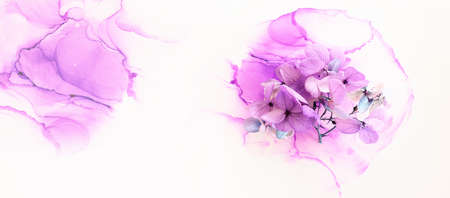 Creative image of pastel violet and pink Hydrangea flowers on artistic ink background. Top view with copy spaceの写真素材