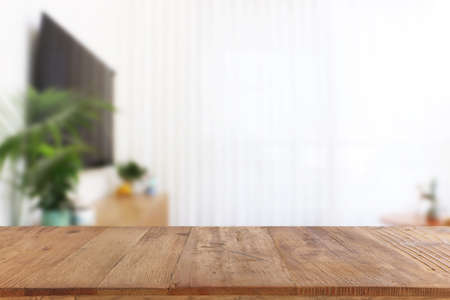 Wooden empty table in front of Living room interior. For product display and presentation