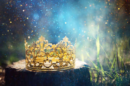 mysterious and magical photo of gold king crown in the woods. Medieval period concept.の写真素材