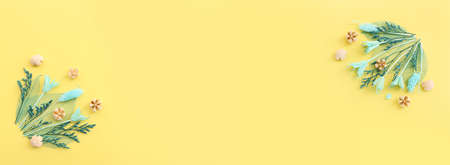 Top view image of autumn forest natural composition over yellow background .Flat lay