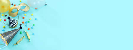Party colorful image over blue background . Top view, flat lay