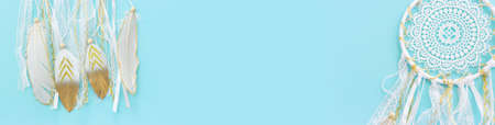 Image of white dream catcher over pastel blue background. Top viewの写真素材