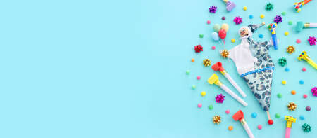 Holidays image of party colorful objects and cute clown over blue background. view from above. bannerの写真素材