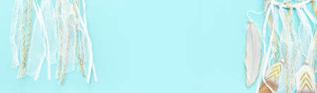 Image of white dream catcher over pastel blue background. Top viewの写真素材