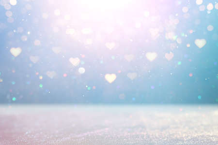 blue and pink glitter vintage lights background. defocused. hearts overlayの写真素材