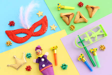 Purim celebration concept (jewish carnival holiday) over colorful background