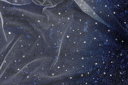 Dark blue with silver stars tulle chiffon texture backgroundの写真素材