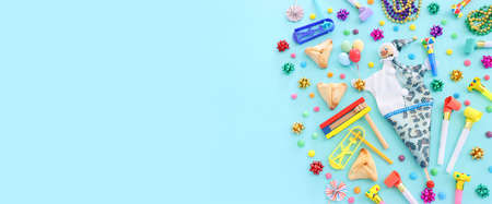Purim celebration concept (jewish carnival holiday) over blue background. Top view, flat lay